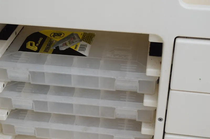 Slide: The Image of 2003 Scout 242 Sportfish boat, white exterior, close-up view of deck and seating area. - 155