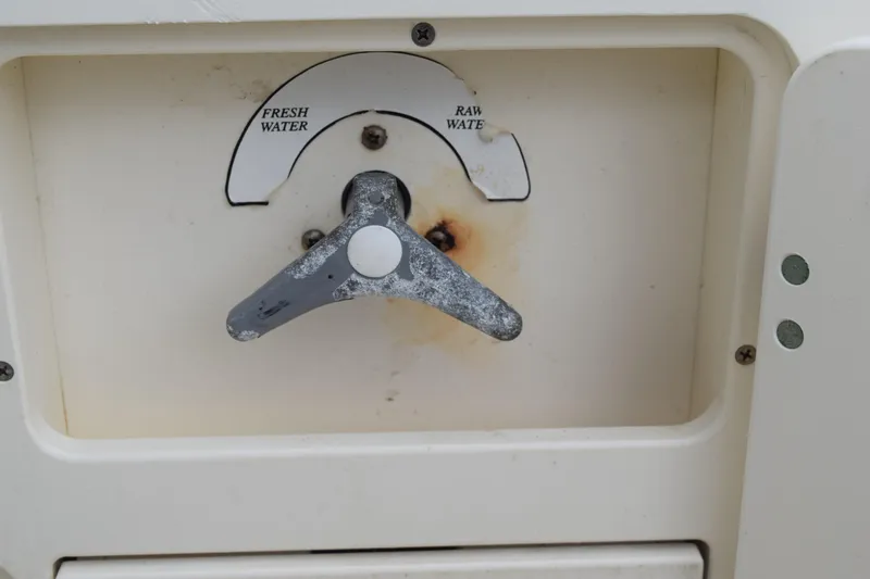 Slide: The Image of 2003 Scout 242 Sportfish boat on trailer, parked on grass. - 156