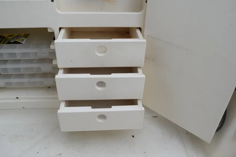 Slide: The Image of 2003 Scout 242 Sportfish boat with T-top, viewed from the front, outdoors. - 158