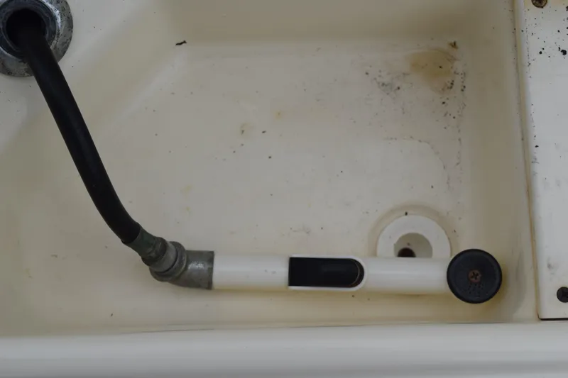 Slide: The Image of 2003 Scout 242 Sportfish boat with Suzuki engine on trailer in grassy area. - 167