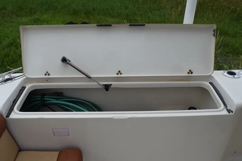 Slide: The Image of 2003 Scout 242 Sportfish boat with T-top under overcast sky. - 171