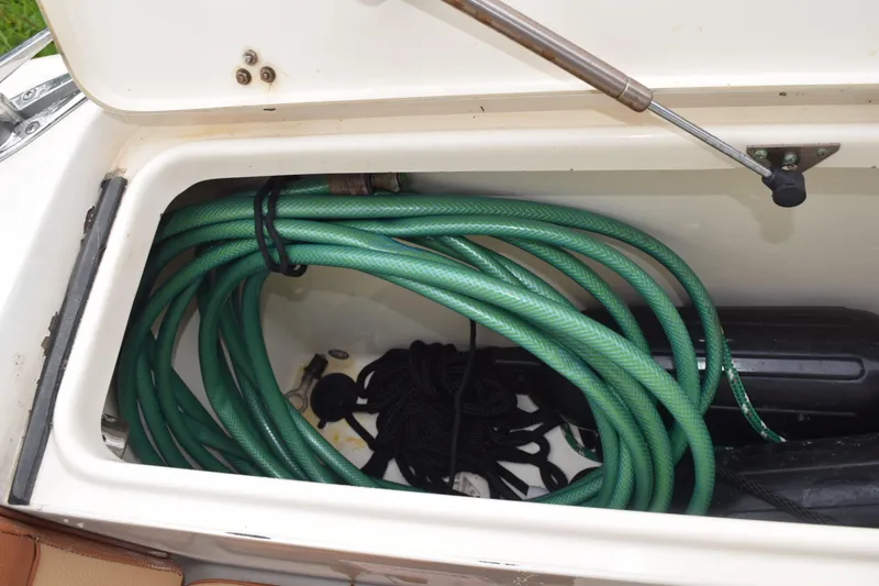 Slide: The Image of 2003 Scout 242 Sportfish boat on trailer, surrounded by trees and other boats. - 172