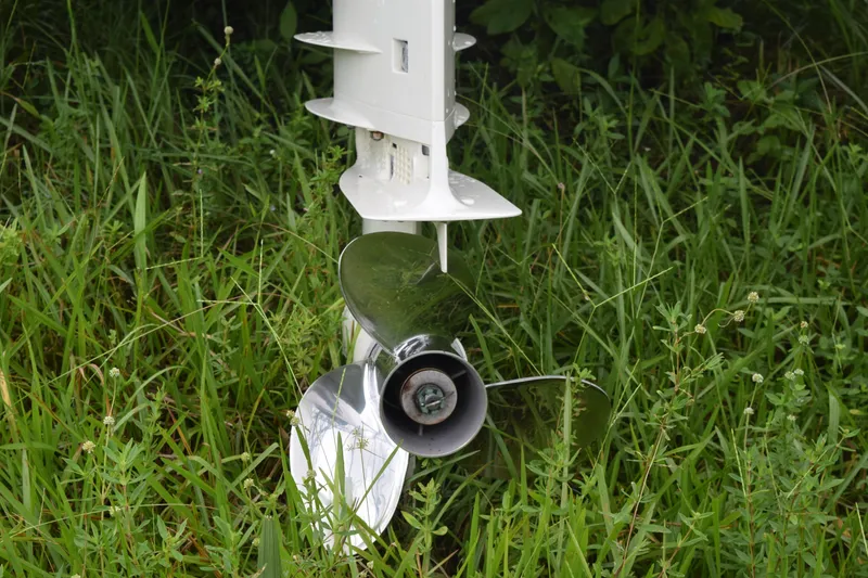 Slide: The Image of 2003 Scout 242 Sportfish boat with red car and greenery in the background. - 23