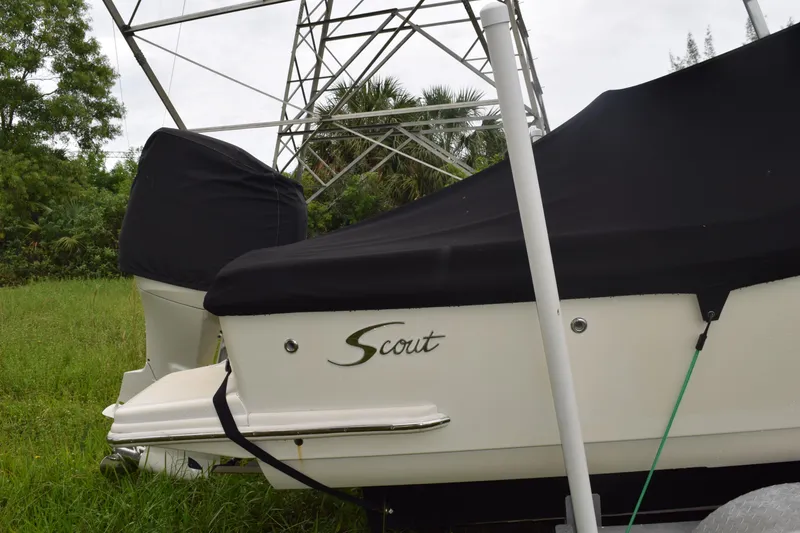 Slide: The Image of Open storage compartment on 2003 Scout 242 Sportfish boat, featuring speaker and metal railing. - 28