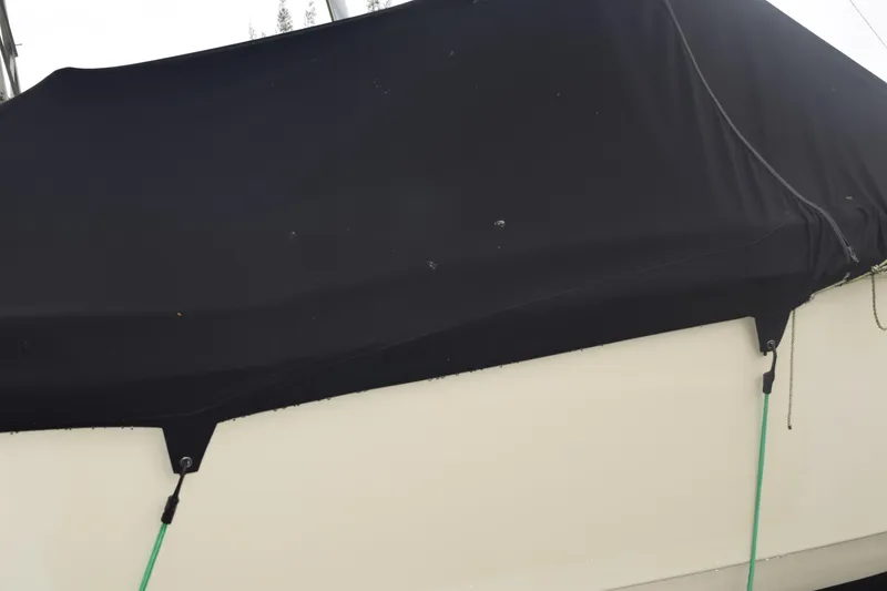 Slide: The Image of Interior view of 2003 Scout 242 Sportfish boat with hooks and a small window. - 32