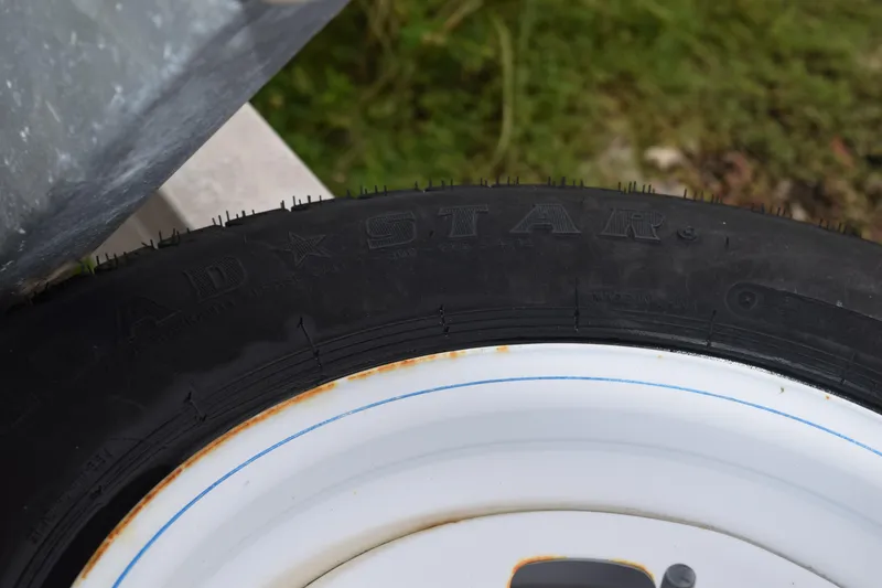 Slide: The Image of Interior view of a 2003 Scout 242 Sportfish boat, featuring a storage compartment. - 43