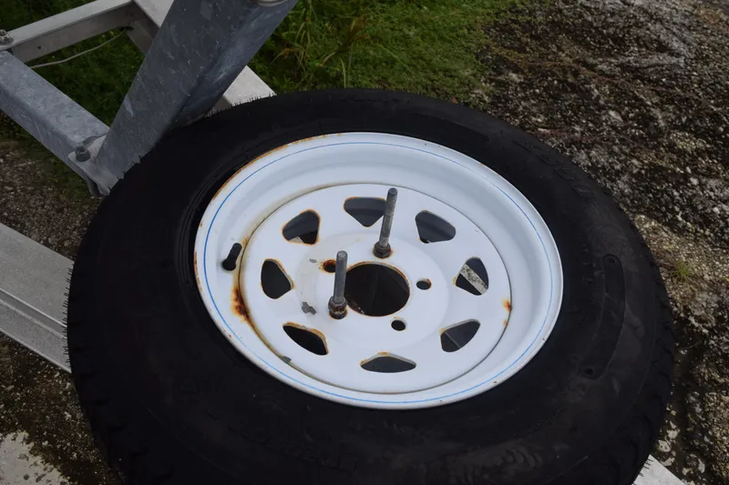 Slide: The Image of Open electrical panel inside a 2003 Scout 242 Sportfish boat, showing wiring and components. - 44