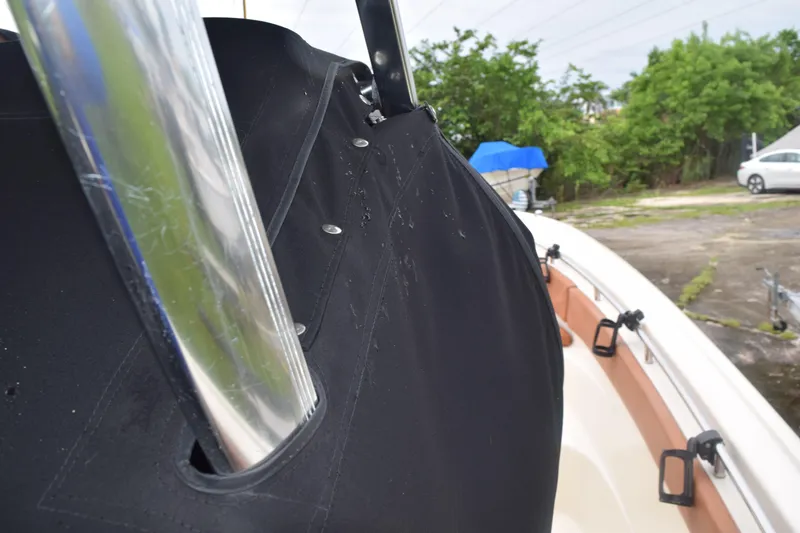 Slide: The Image of 2003 Scout 242 Sportfish boat interior with chrome details and logo. - 58