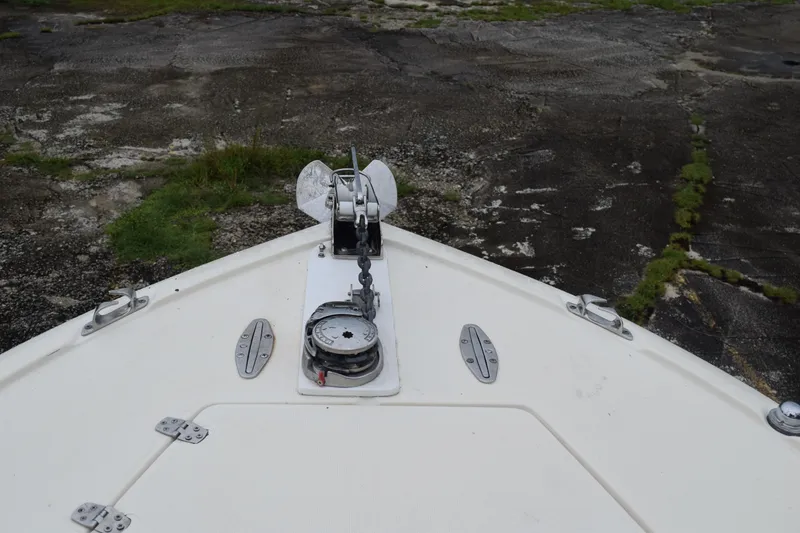 Slide: The Image of 2003 Scout 242 Sportfish boat interior with tan and brown seating, Suzuki engine visible. - 63