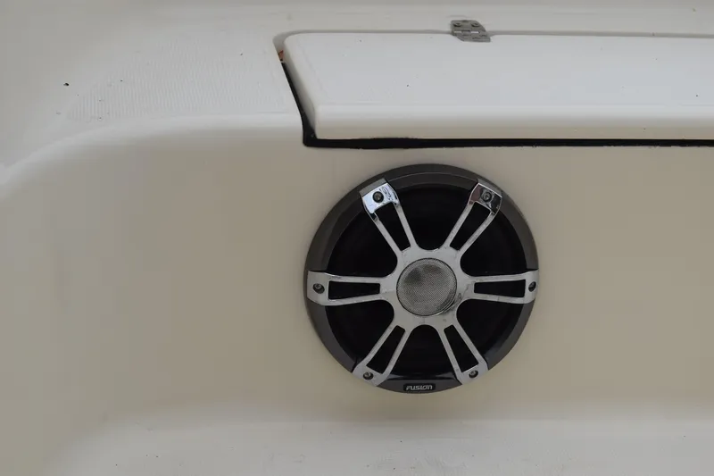 Slide: The Image of 2003 Scout 242 Sportfish boat interior with brown seating and Suzuki outboard motor. - 77