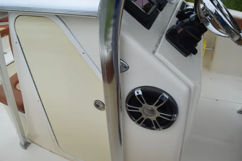 Slide: The Image of Open storage compartment on 2003 Scout 242 Sportfish boat, showing interior details and hardware. - 80