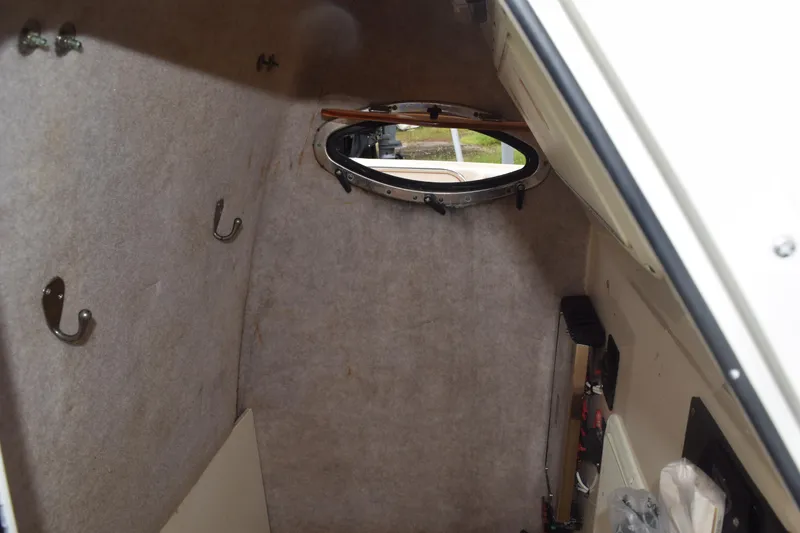 Slide: The Image of Coiled hose and nozzle in 2003 Scout 242 Sportfish boat compartment. - 85