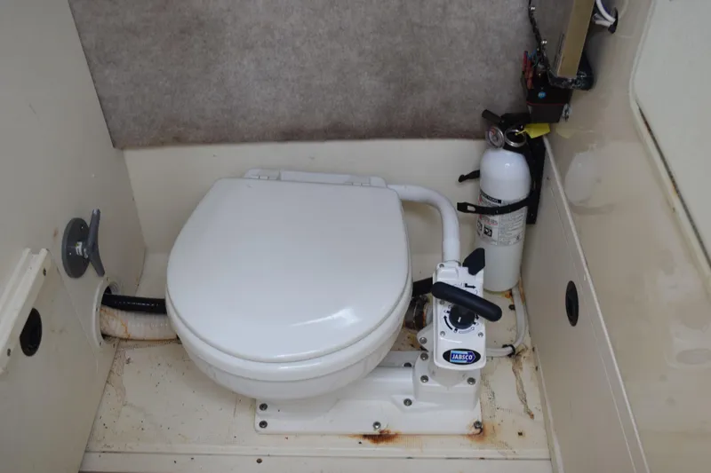 Slide: The Image of Storage compartment with ropes and fenders on a 2003 Scout 242 Sportfish boat. - 89