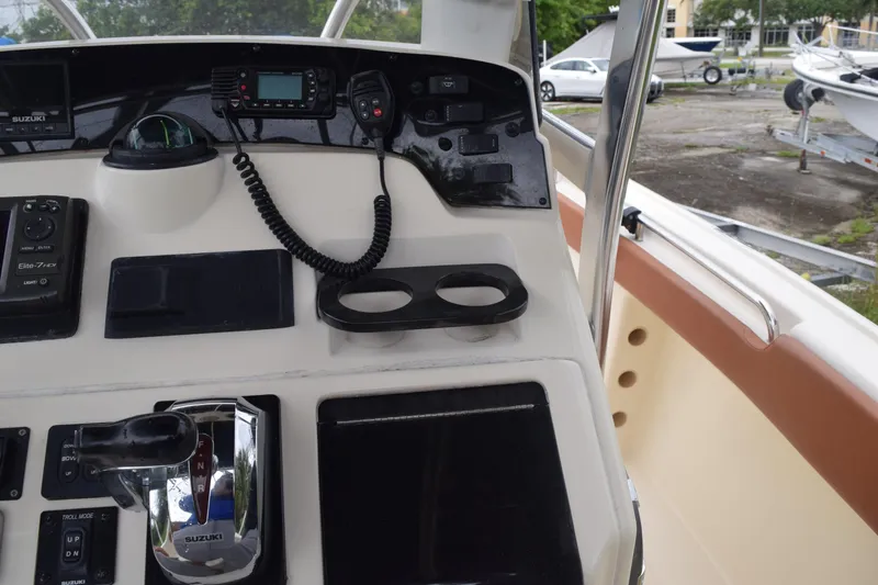 Slide: The Image of Control panel of a 2003 Scout 242 Sportfish boat with Suzuki throttle and electronics. - 96