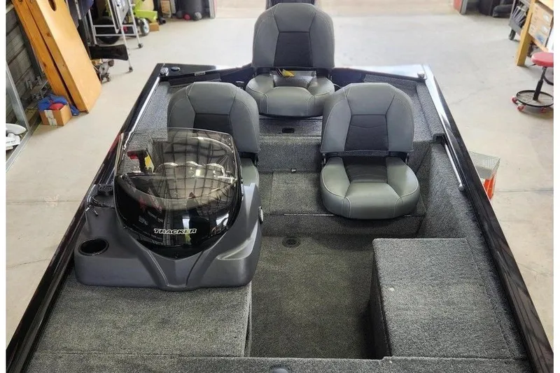 Slide: The Image of 2026 Tracker Pro 170 boat interior with three gray seats and steering console. - 10