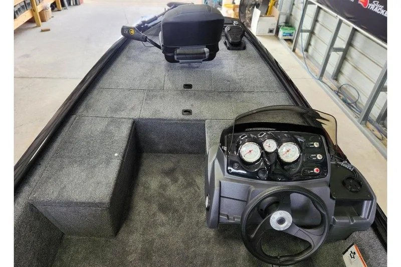 Slide: The Image of 2026 Tracker Pro 170 boat interior with steering wheel and control panel in a garage setting. - 11