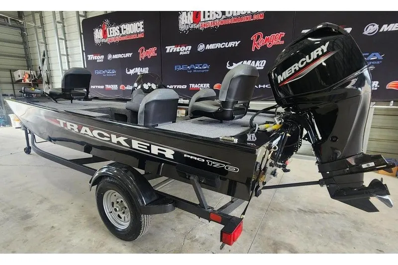 Slide: The Image of 2026 Tracker Pro 170 boat with Mercury engine in showroom setting. - 3