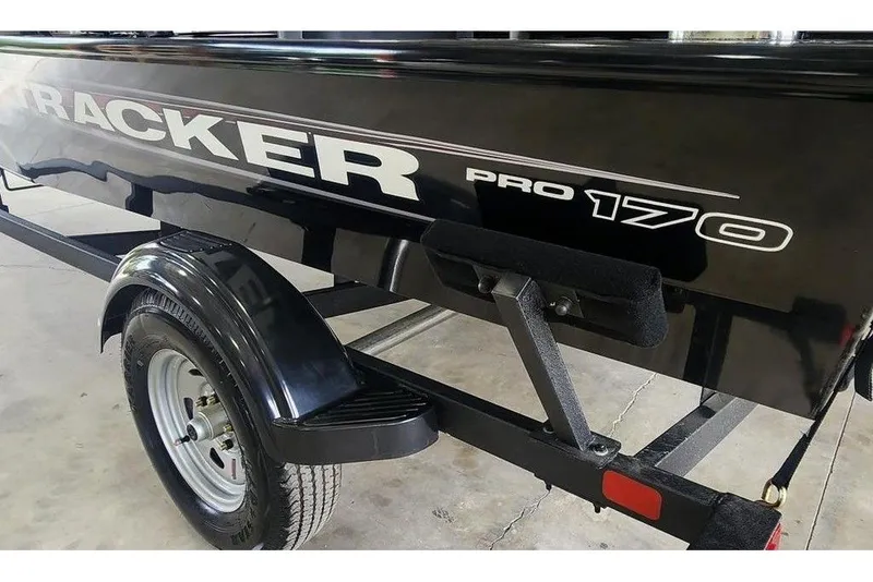 Slide: The Image of 2026 Tracker Pro 170 boat trailer, black finish, close-up view. - 8