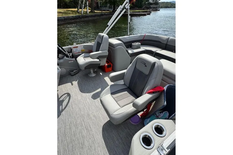 Slide: The Image of 2024 Bennington 22 SSRX boat seat storage with yellow life jackets. - 12