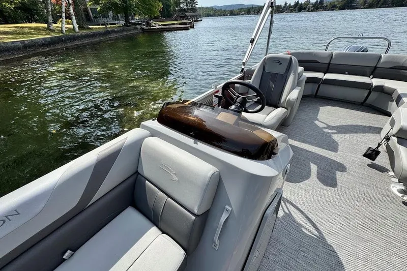 Slide: The Image of 2024 Bennington 22 SSRX pontoon boat with Yamaha motor docked by clear lake. - 18