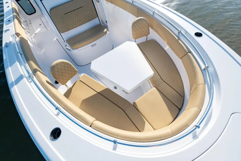 Slide: The Image of Manufacturer Provided Image: 2025 Sportsman Open 252 Center Console boat with tan seating and white table. - 4