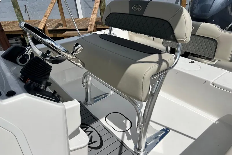 Slide: The Image of 2026 Key West 189 FS boat interior with steering wheel and cushioned seating. - 17