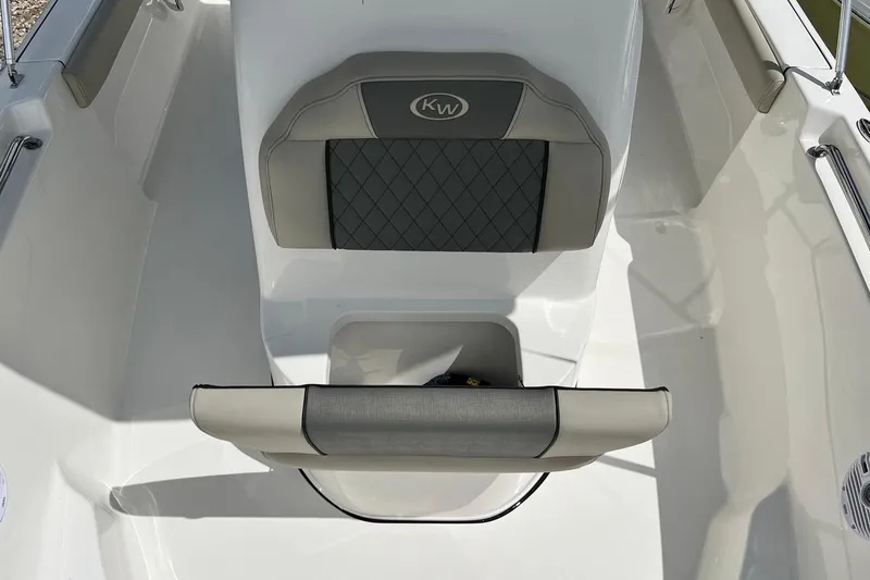 Slide: The Image of 2026 Key West 189 FS boat interior with cushioned seating and storage compartment. - 19