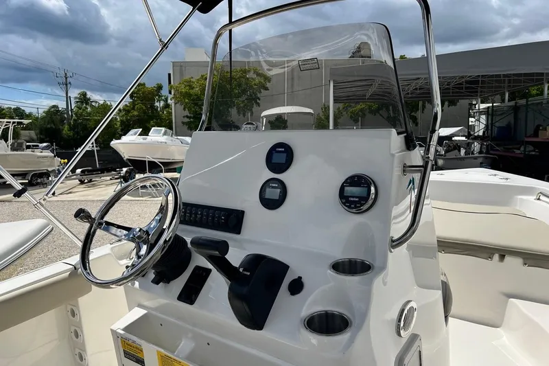 Slide: The Image of 2026 Key West 189 FS boat dashboard with steering wheel and controls. - 9