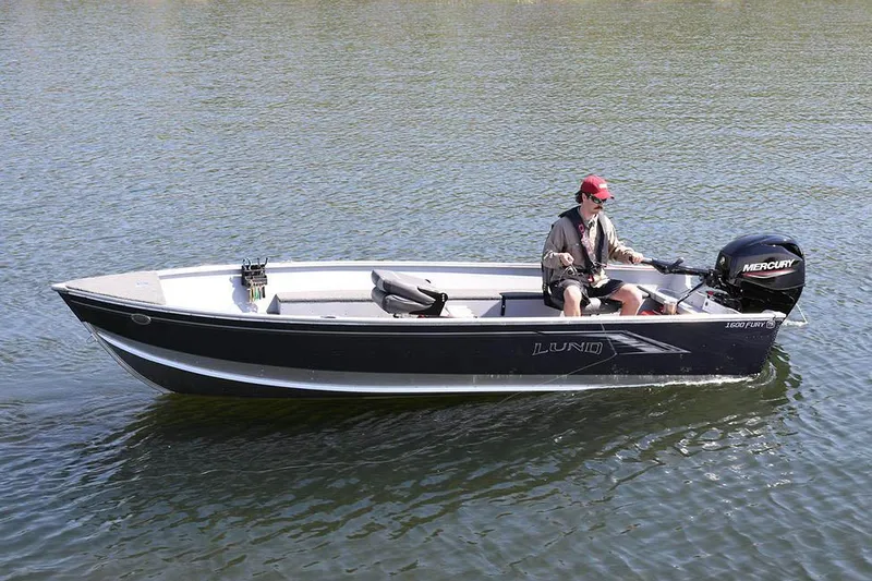 Slide: The Image of Manufacturer Provided Image: 2025 Lund 1600 Fury Tiller boat on water with person steering. - 15
