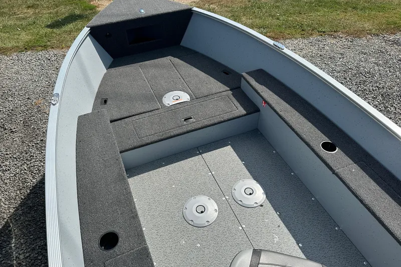Slide: The Image of 2025 Lund 1600 Fury Tiller boat interior with gray carpet and seating. - 5