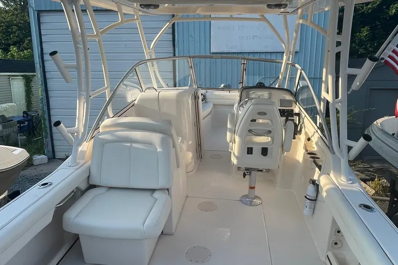 Slide: The Image of 2020 Grady-White Freedom 255 boat interior with white seating and steering console. - 2