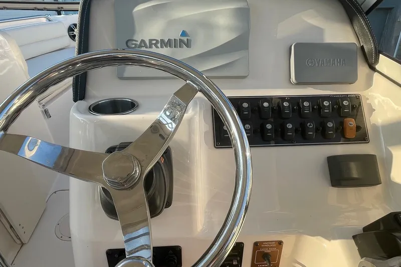 Slide: The Image of Steering wheel and control panel of 2020 Grady-White Freedom 255 boat with Garmin and Yamaha systems. - 6