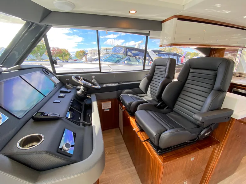 Slide: The Image of Interior of 2025 Riviera 465 SUV yacht with modern helm and leather seats. - 12