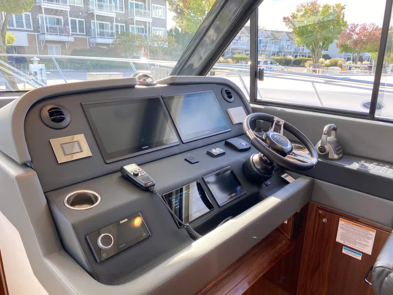 Slide: The Image of 2025 Riviera 465 SUV helm with modern navigation screens and controls. - 13