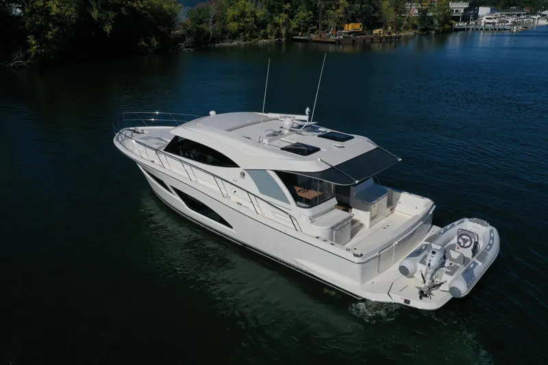 Slide: The Image of 2025 Riviera 465 SUV luxury yacht cruising on a serene lake. - 28