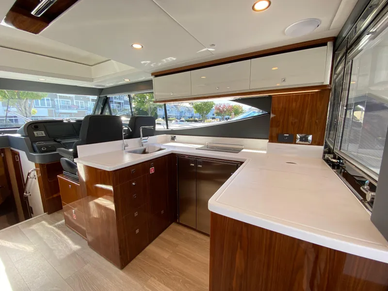Slide: The Image of Luxurious interior of 2025 Riviera 465 SUV yacht with modern kitchen design. - 6
