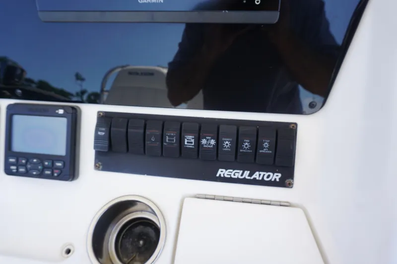 Slide: The Image of Control panel of 2012 Regulator 32 Forward Seating boat with switches and Garmin display. - 11