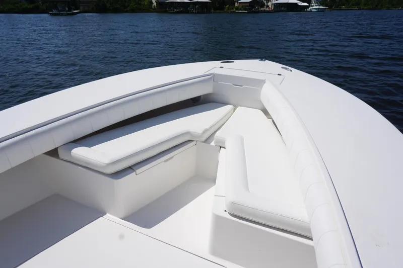 Slide: The Image of 2012 Regulator 32 Forward Seating boat with white cushioned seats on calm water. - 43