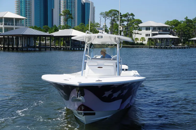 Slide: The Image of 2012 Regulator 32 Forward Seating boat on water near waterfront homes. - 53