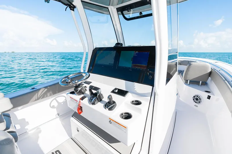 Slide: The Image of Manufacturer Provided Image: 2025 Sportsman Open 282 Center Console boat interior with modern controls and ocean view. - 11