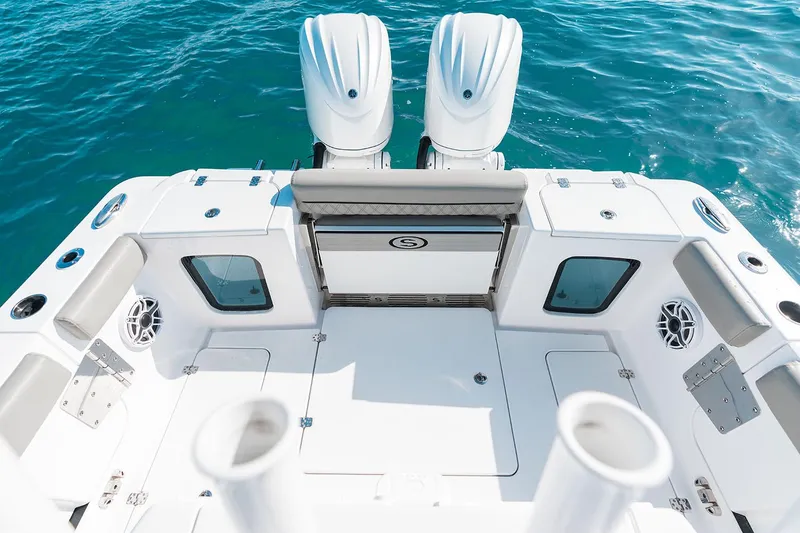 Slide: The Image of Manufacturer Provided Image: 2025 Sportsman Open 282 Center Console boat deck with twin engines on blue water. - 17