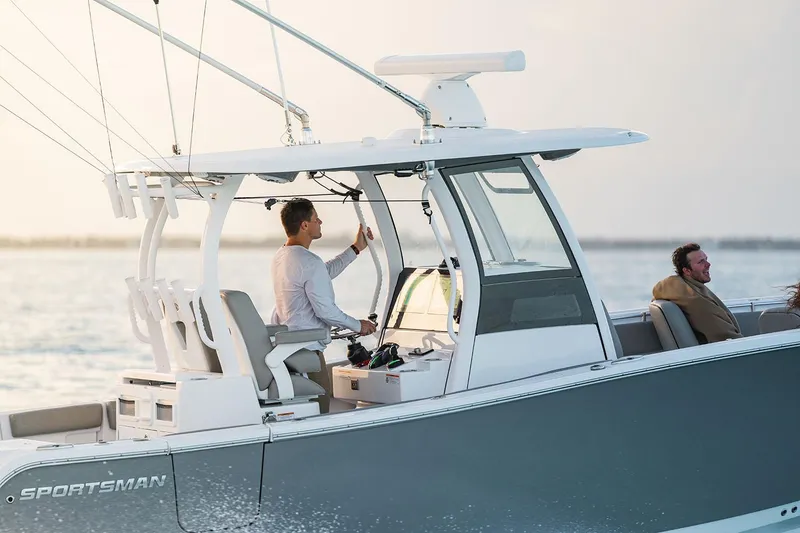 Slide: The Image of Manufacturer Provided Image: 2025 Sportsman Open 282 Center Console boat cruising on water at sunset. - 4