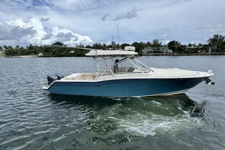 The Image of 2018 Grady-White Freedom 325 boat on calm water, under a cloudy sky. - 0