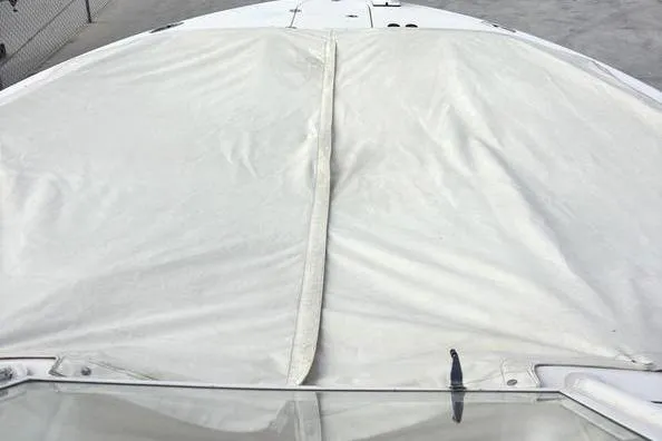Slide: The Image of 2018 Grady-White Freedom 325 boat with protective cover, docked in a marina. - 10