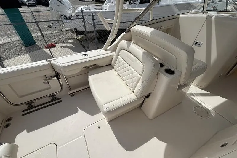 Slide: The Image of 2018 Grady-White Freedom 325 boat interior with white seating and cup holders. - 14