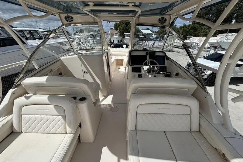Slide: The Image of 2018 Grady-White Freedom 325 boat interior with luxurious seating and modern dashboard. - 17