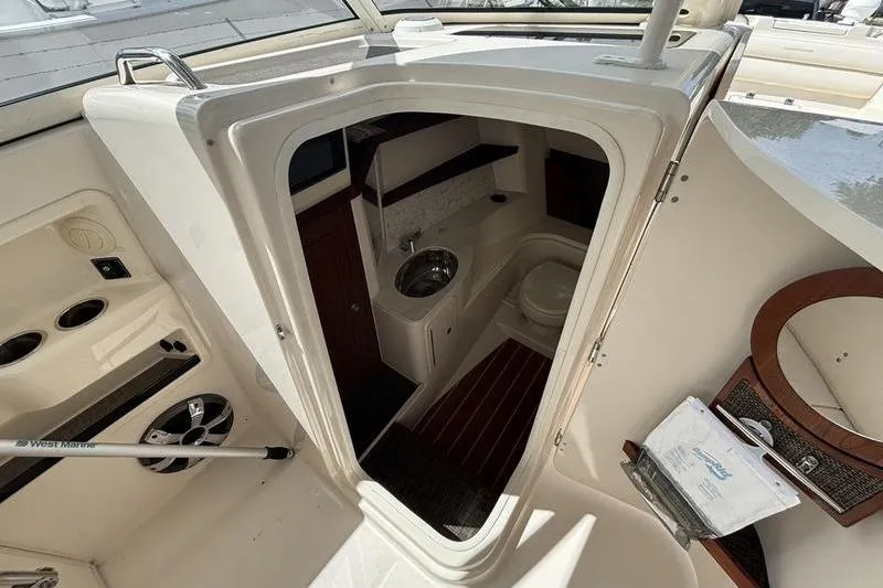 Slide: The Image of 2018 Grady-White Freedom 325 boat interior with compact bathroom and sink. - 18