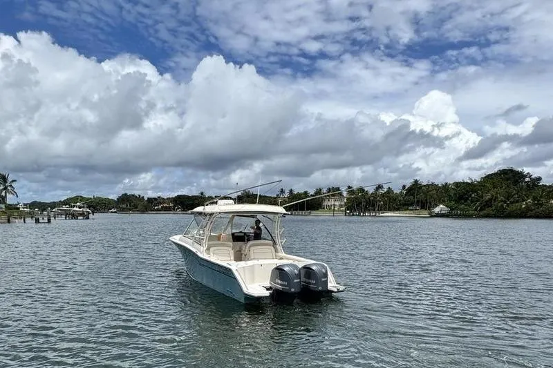 Slide: The Image of 2018 Grady-White Freedom 325 boat on calm water under cloudy sky. - 2