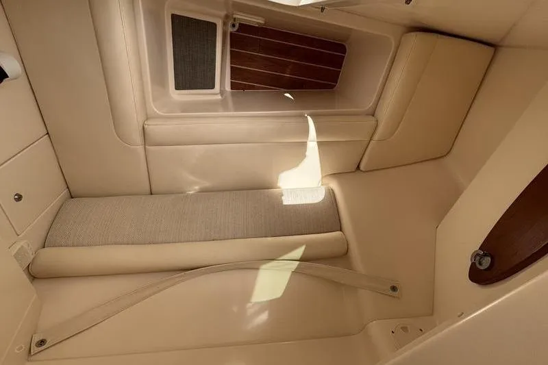 Slide: The Image of Interior cabin of 2018 Grady-White Freedom 325 boat, featuring beige upholstery and wooden accents. - 20
