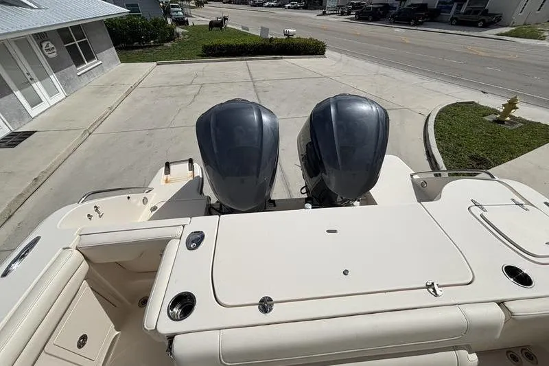 Slide: The Image of 2018 Grady-White Freedom 325 boat with dual outboard engines, docked on a sunny day. - 22